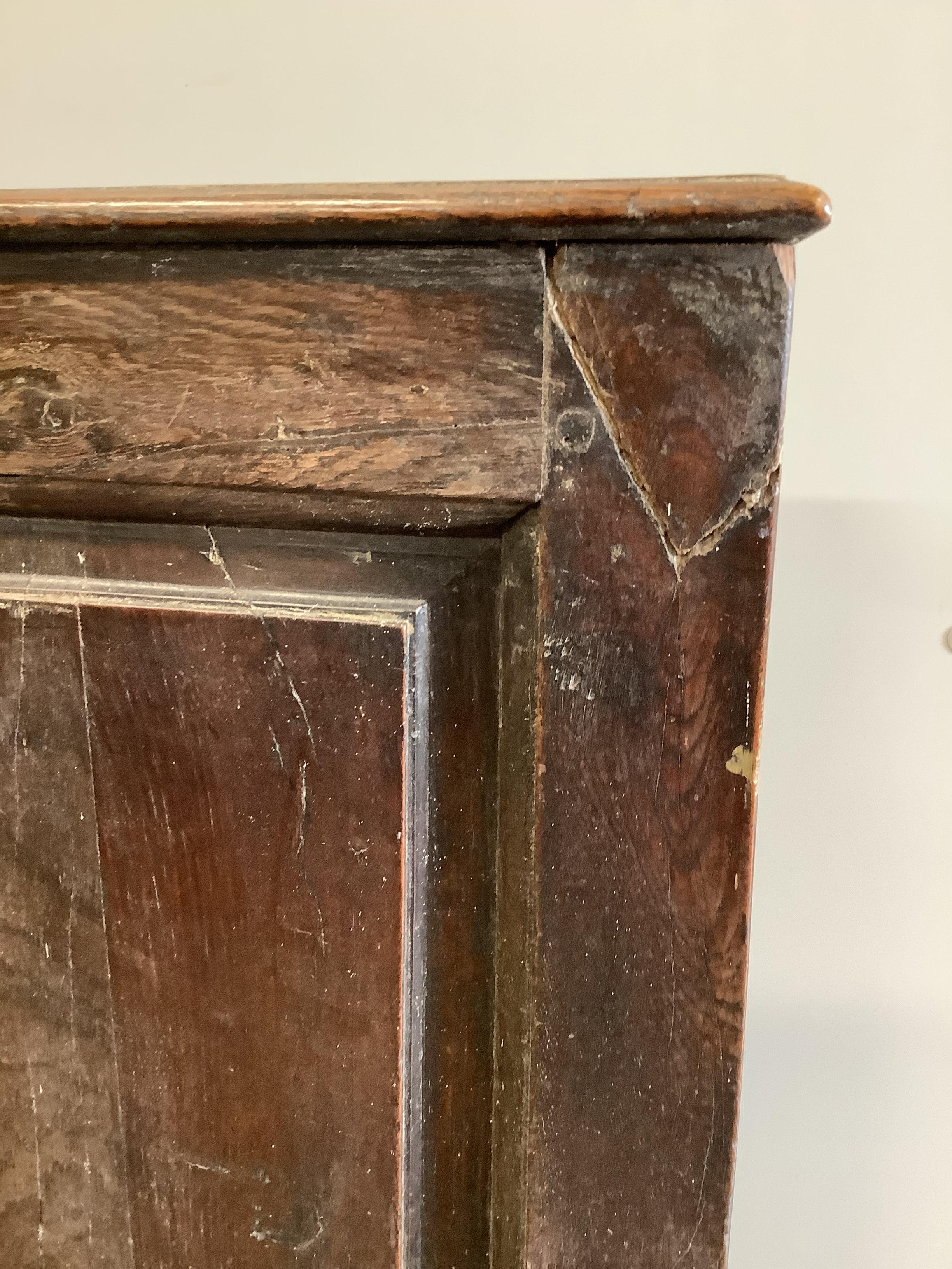 An 18th century oak settle, width 193cm, depth 60cm, height 108cm (front stretcher a.f.)